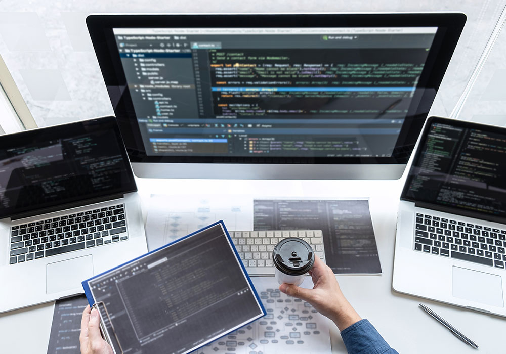 Developer programmer working on project in software development computer in IT company office