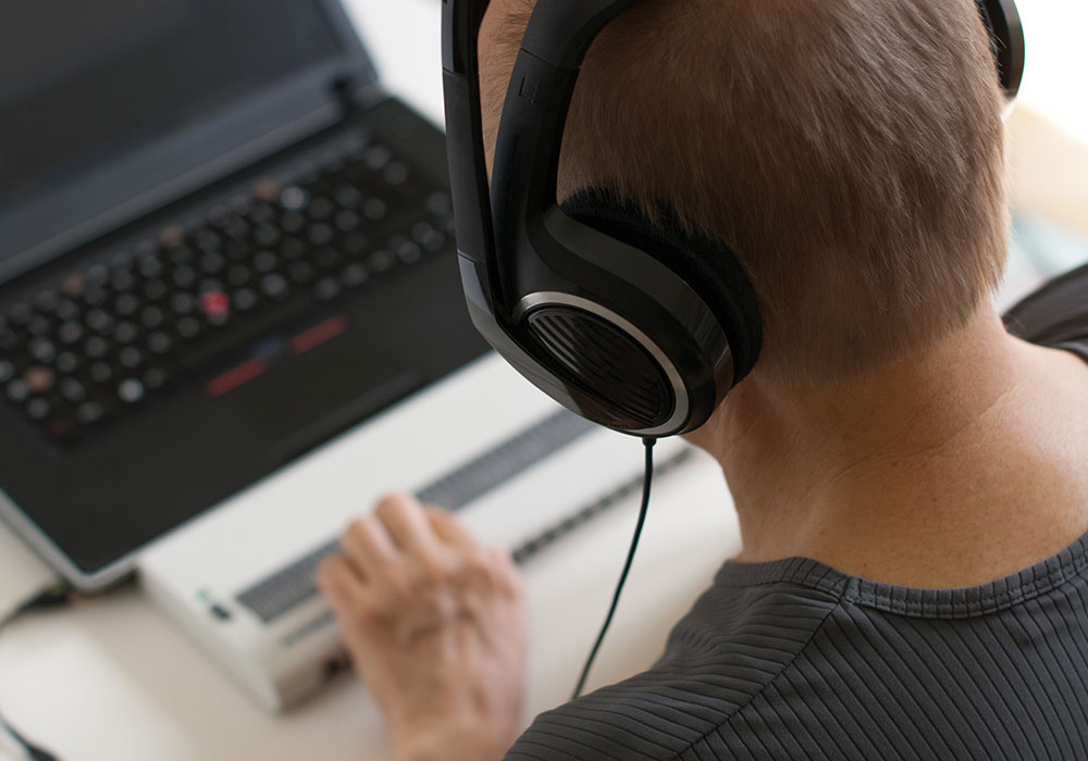 man on a laptop using keyboard assistive technology for work training
